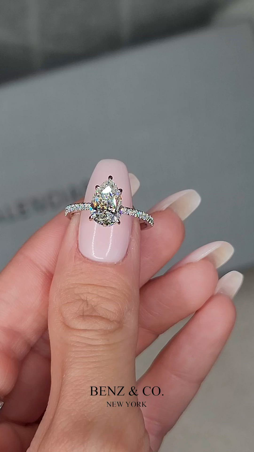 This may contain: a woman's manicured nails with a ring on top of her finger and a diamond in the middle