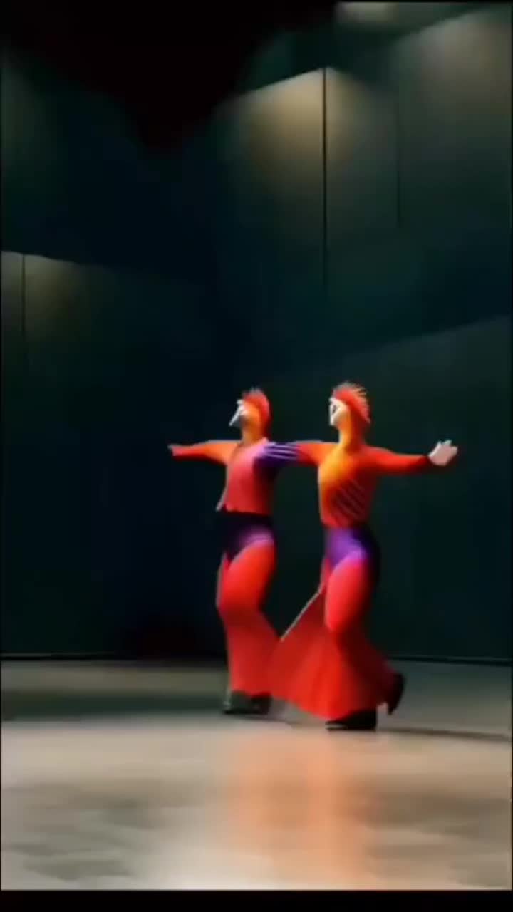 This may contain: two women in red and purple dresses are dancing