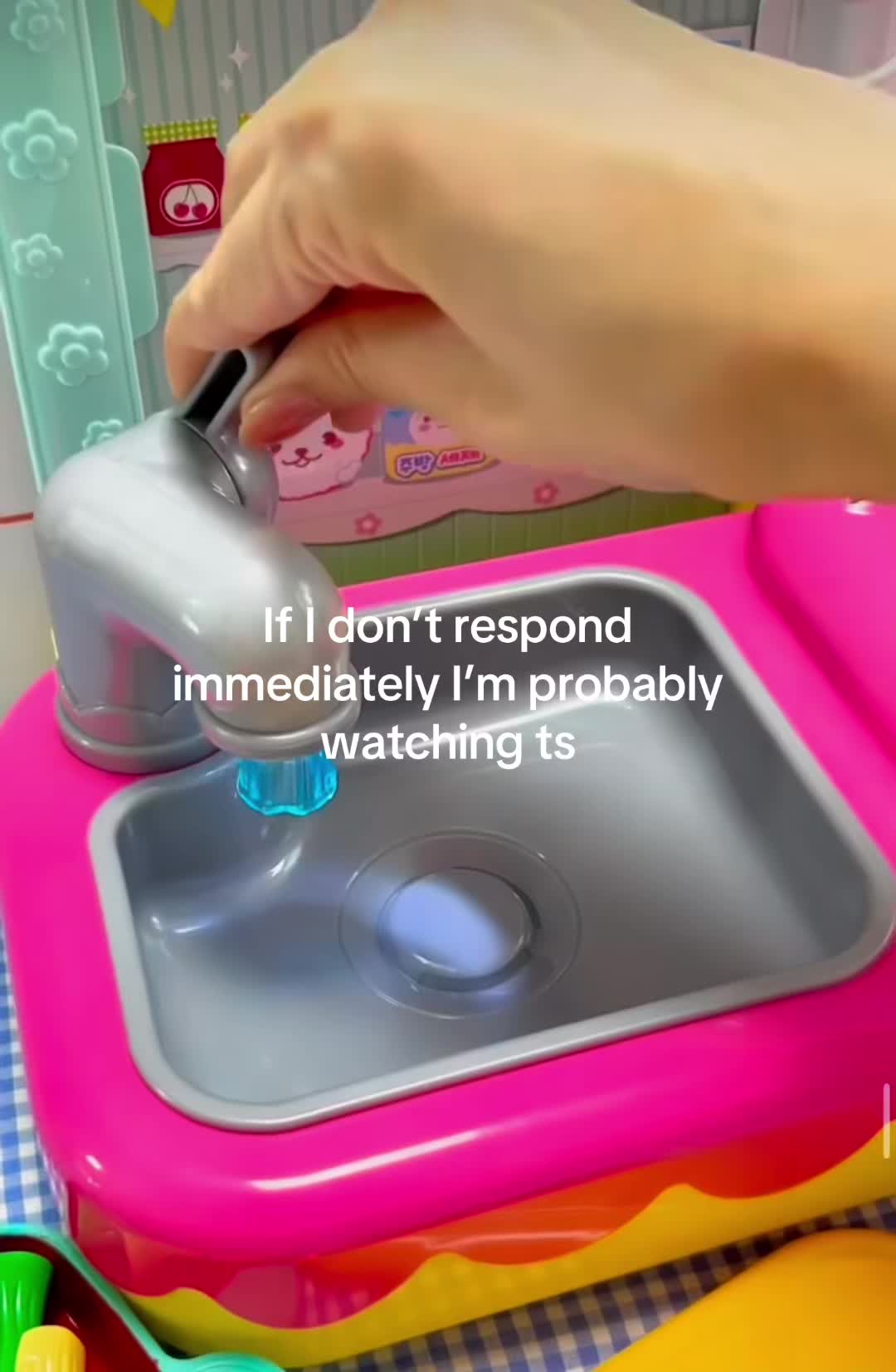 This may contain: a pink toy sink with two plastic fish in it's bottom and the words if i don't respond immediately, i'm probably watching ts