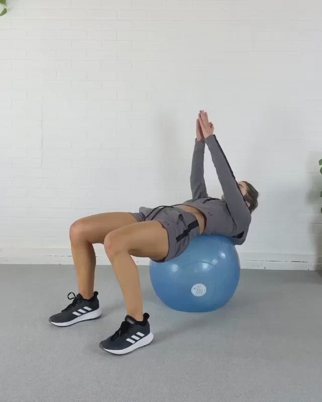 This may contain: a woman is doing exercises on an exercise ball