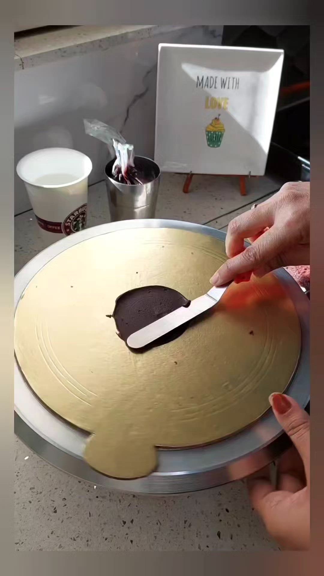 This may contain: a person is using a large knife to cut out the top of a cookie sheet