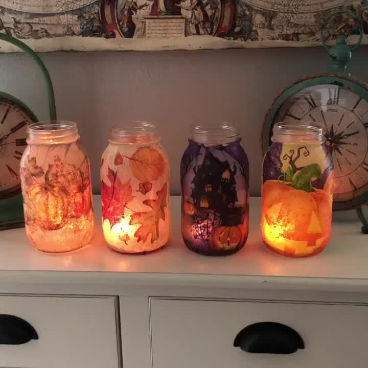 This may contain: some jars with lights in them sitting on a shelf