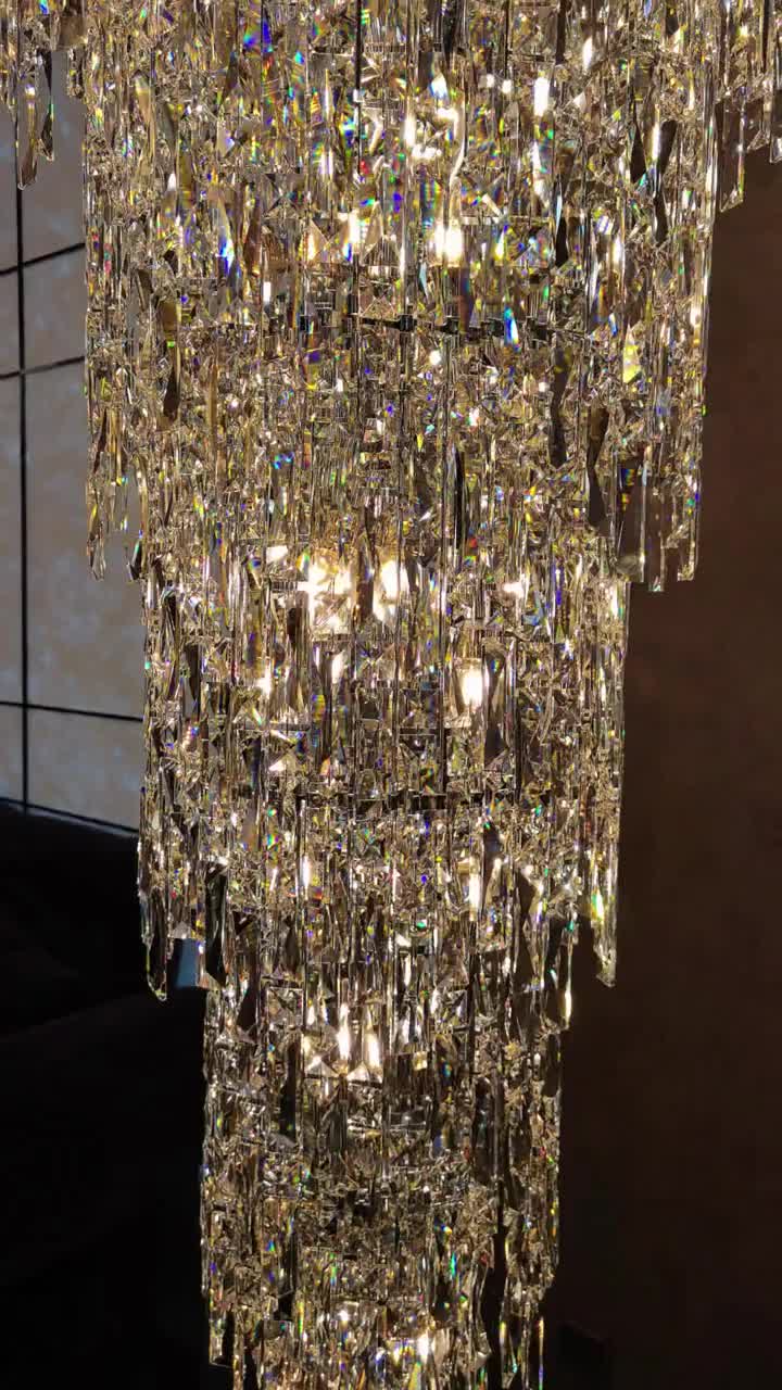 This may contain: a large crystal chandelier hanging from the ceiling