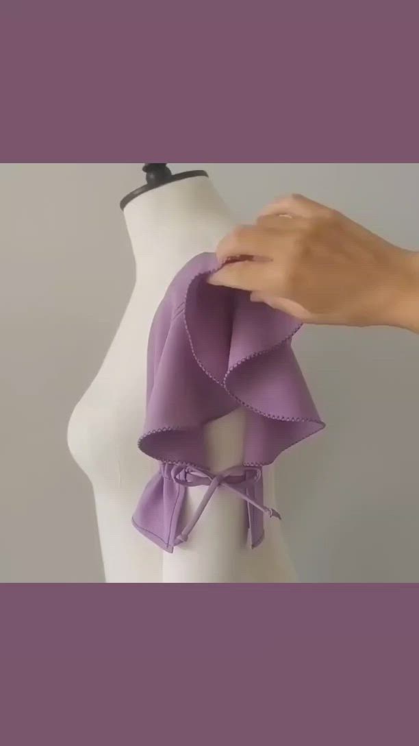 This may contain: a mannequin's torso with purple ruffles on it