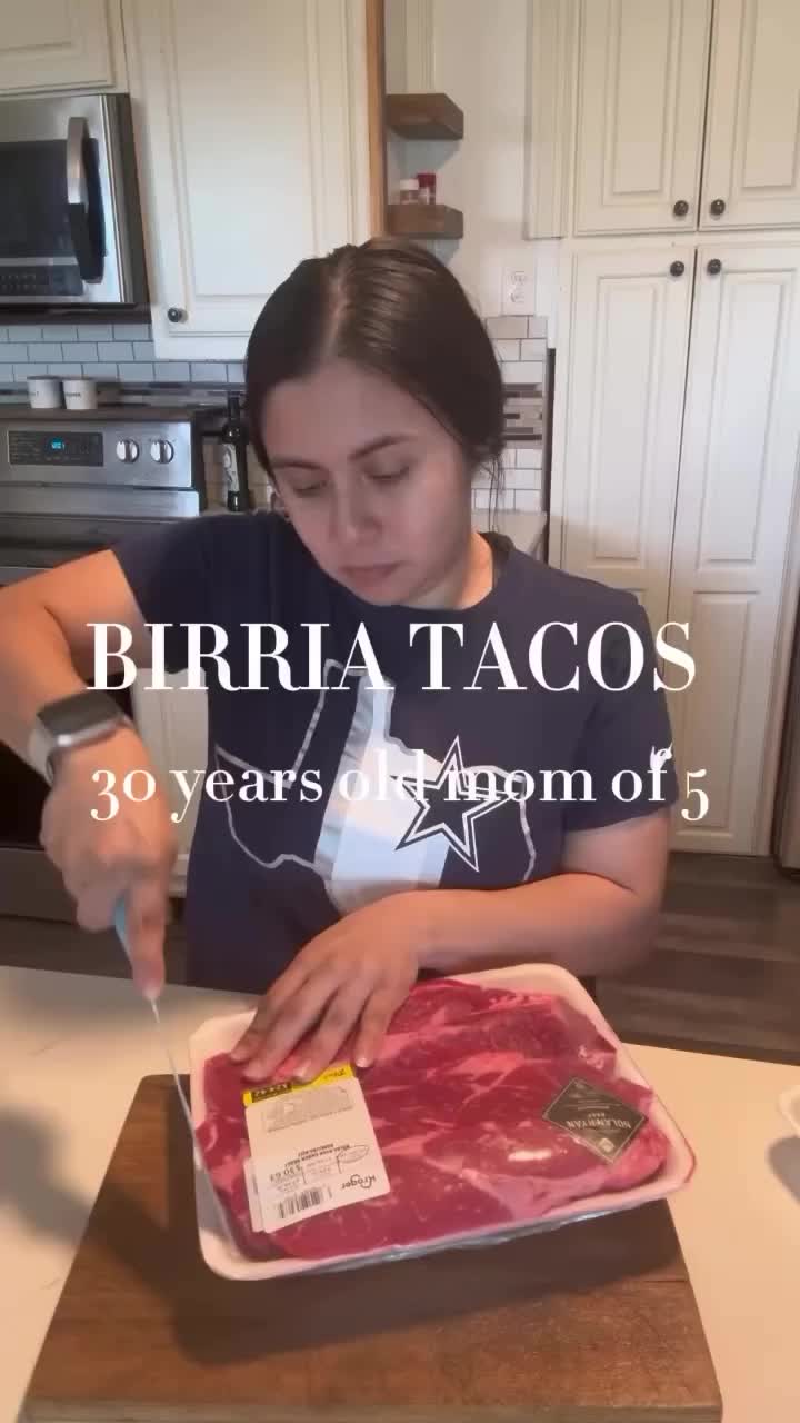 This may contain: a woman cutting up meat on top of a counter