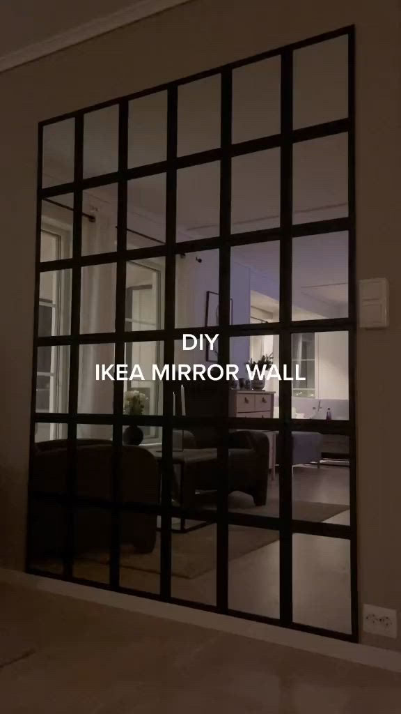 This may contain: the reflection of a living room and dining room in a glass door that says diy ikea mirror wall