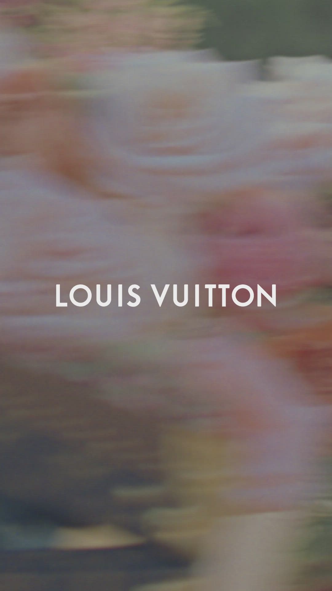 This may contain: blurry image of pink flowers with the words louis vuitton