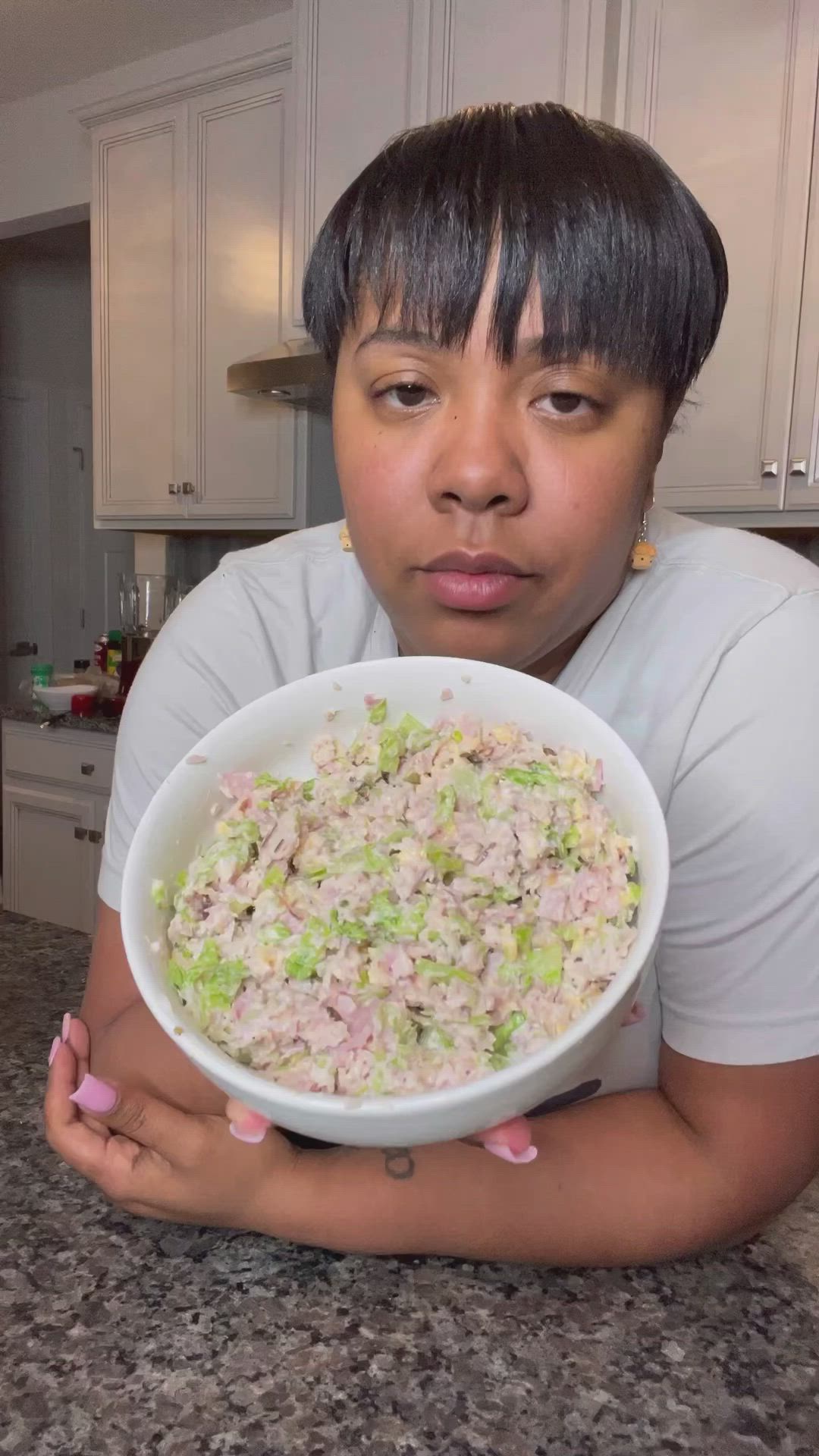 This may contain: a woman holding a bowl of food in her hands