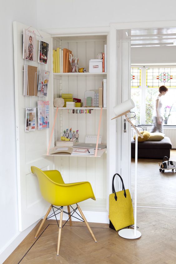 Small foldable desk hidden in a bookcase.