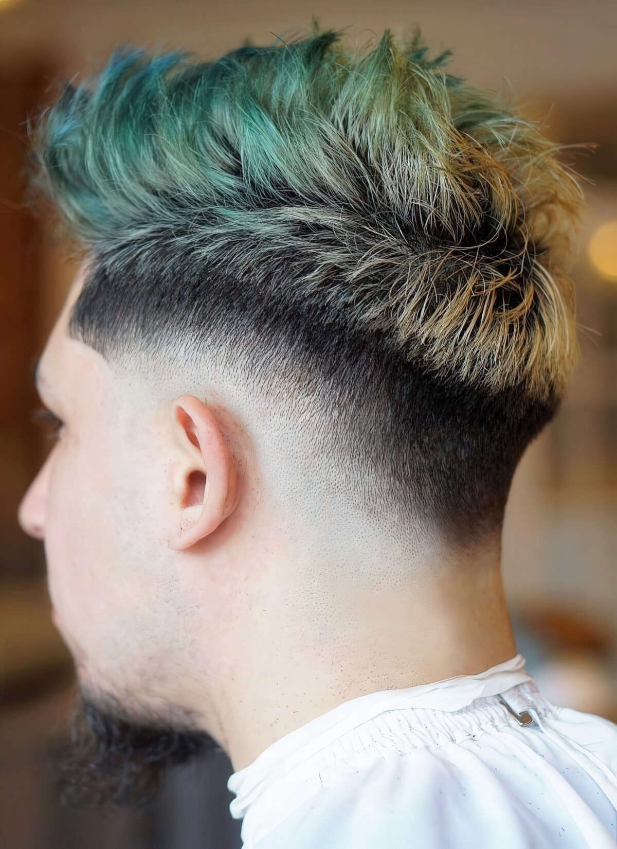 A dyed drop fade faux hawk is a bold idea for those who dare.