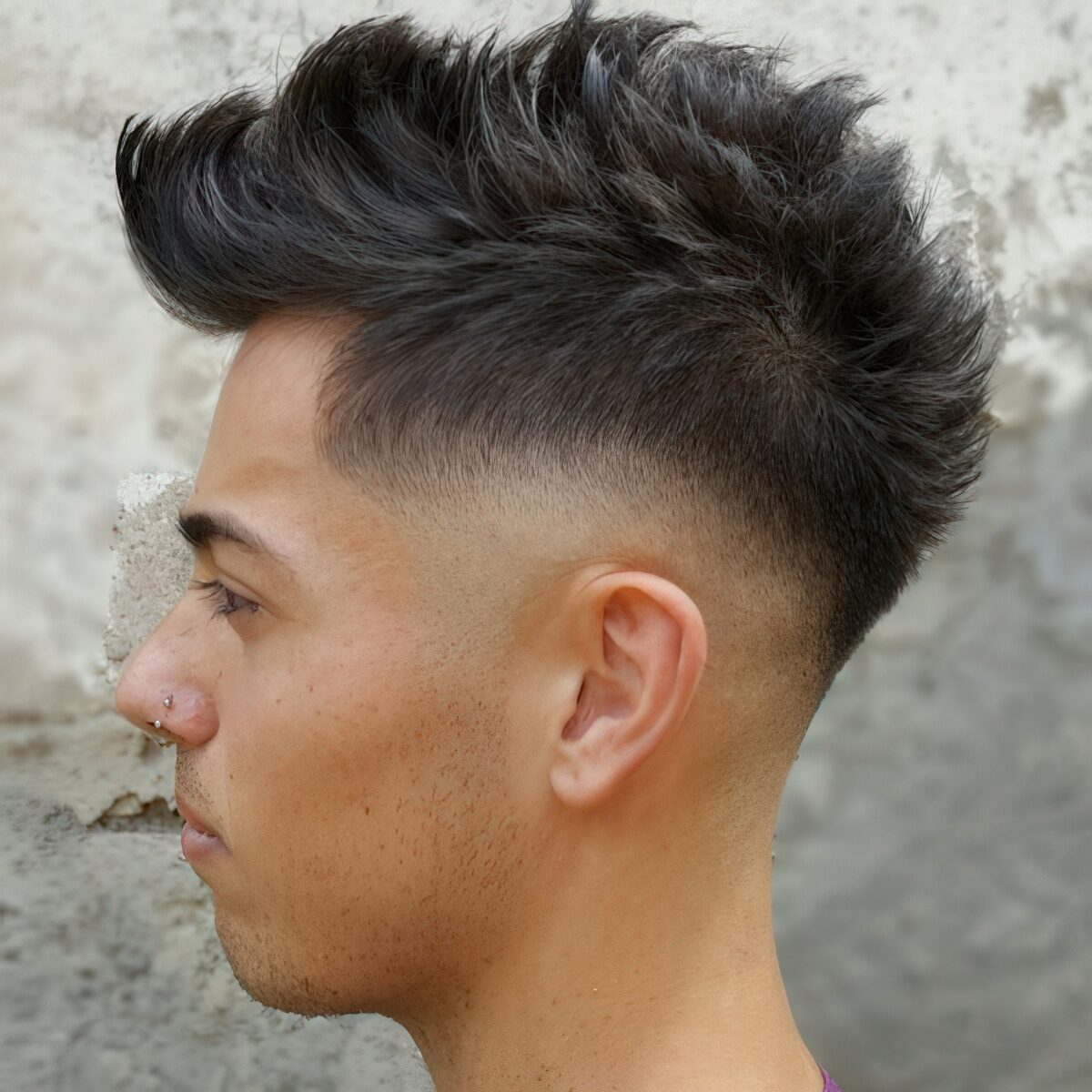 A long faux hawk with fade and curved hair is a trendy idea with much volume.