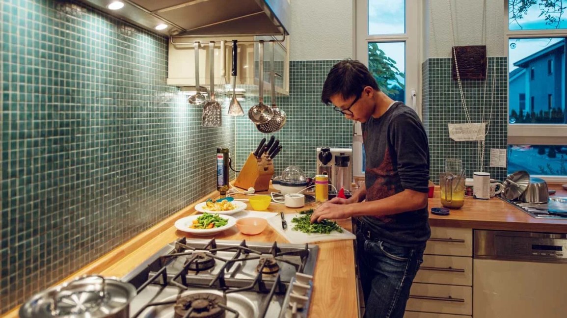 young man preparing meal in kitchen