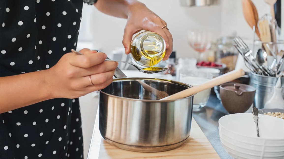 pouring cooking oil into a spoon