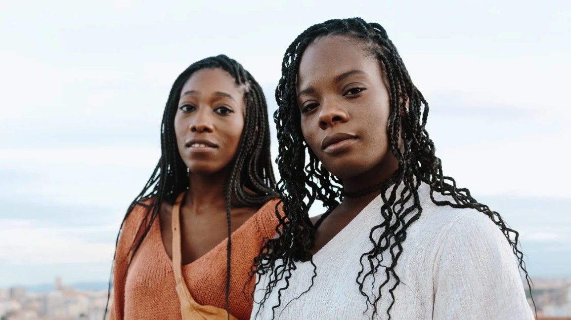 Two Black women stand next to each other.