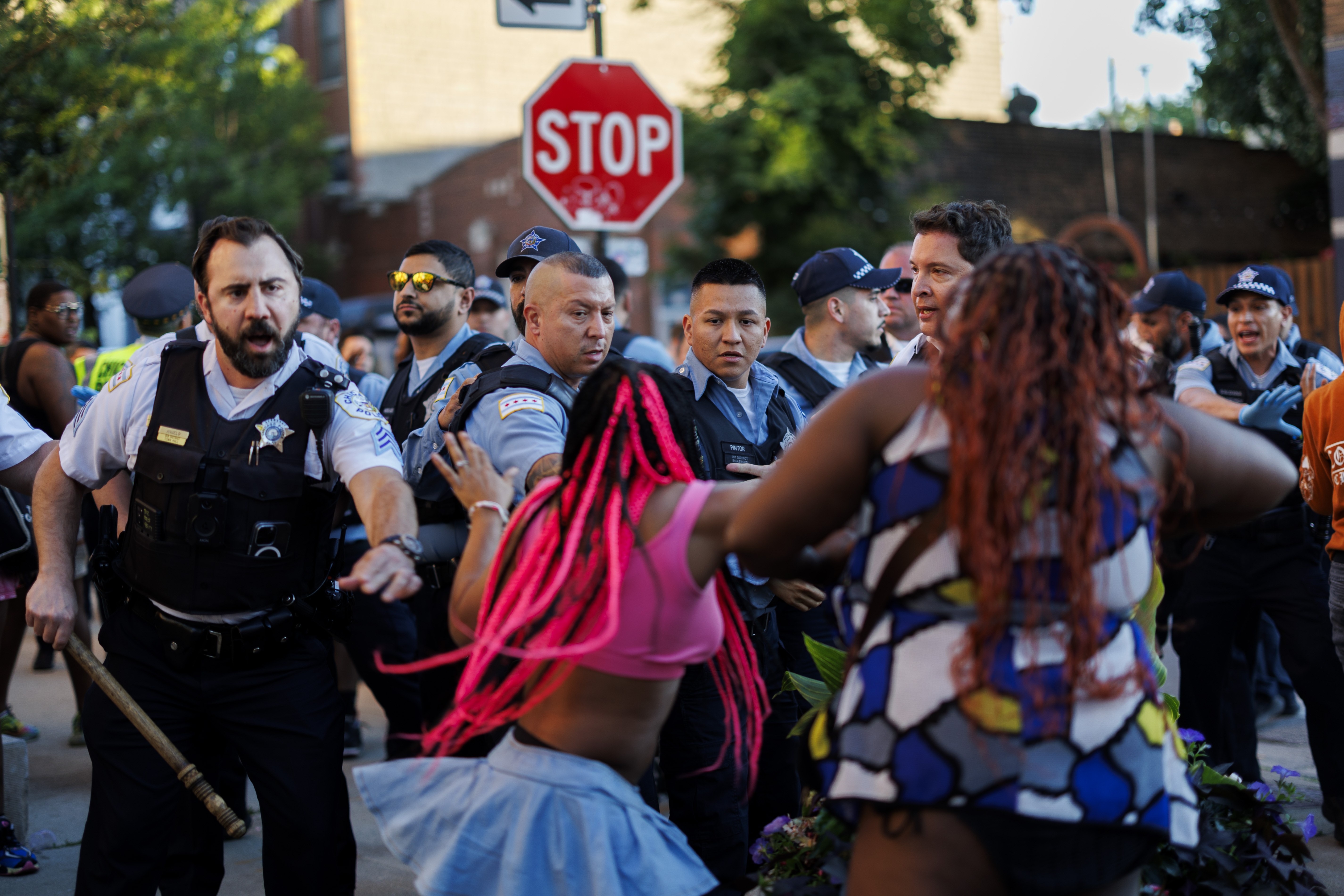 Police attempt to disperse a group of people as they detain a person on West School Street after the Chicago Pride Parade on June 30, 2024. (Armando L. Sanchez/Chicago Tribune)