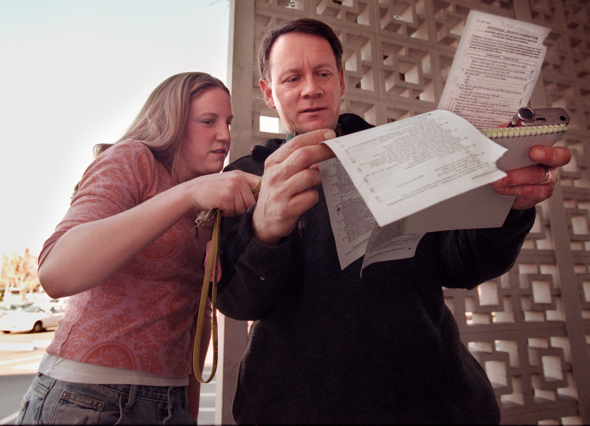 Anne Richards and her father, Gary Richards, compare questions on their driving tests in 2000 when the DMV updated their test and as many as three out of four people were flunking it. Mr. Roadshow and his daughter, Anne, a new 16-yr old driver, took the test to see who knows the rules of the road better. (Rick E. Martin/Mercury News Archives)