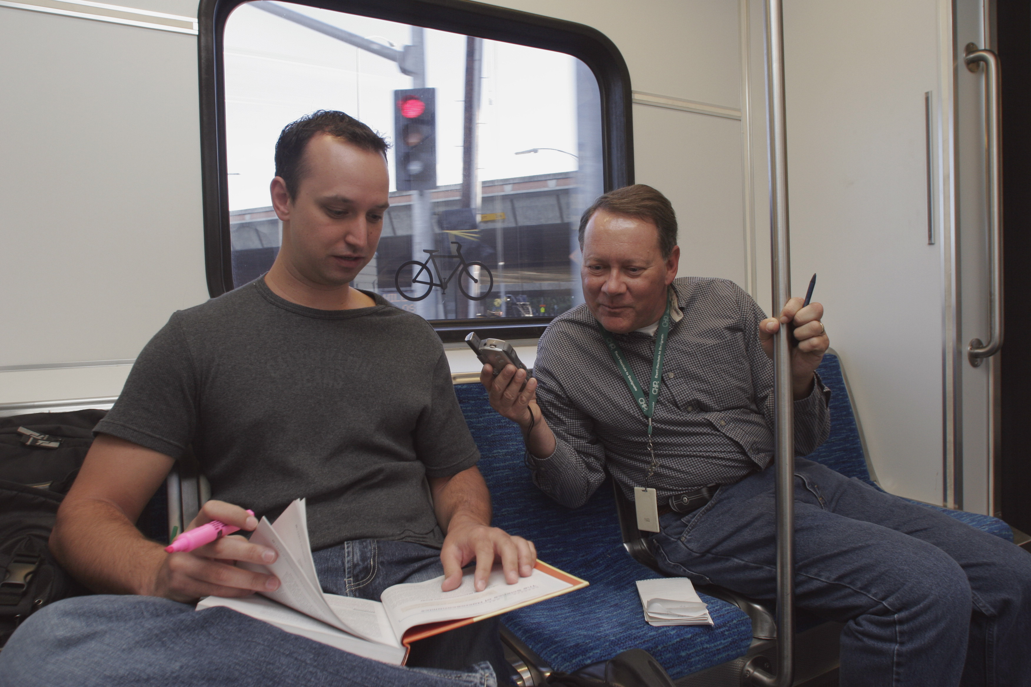 Gerard Bessette ,left, a SJSU student majoring in economics, is interviewed by Gary Richards, Mr. Roadshow, as he rides the new light rail line in 2005. (Len Vaughn-Lahman/ Mercury News Archive)