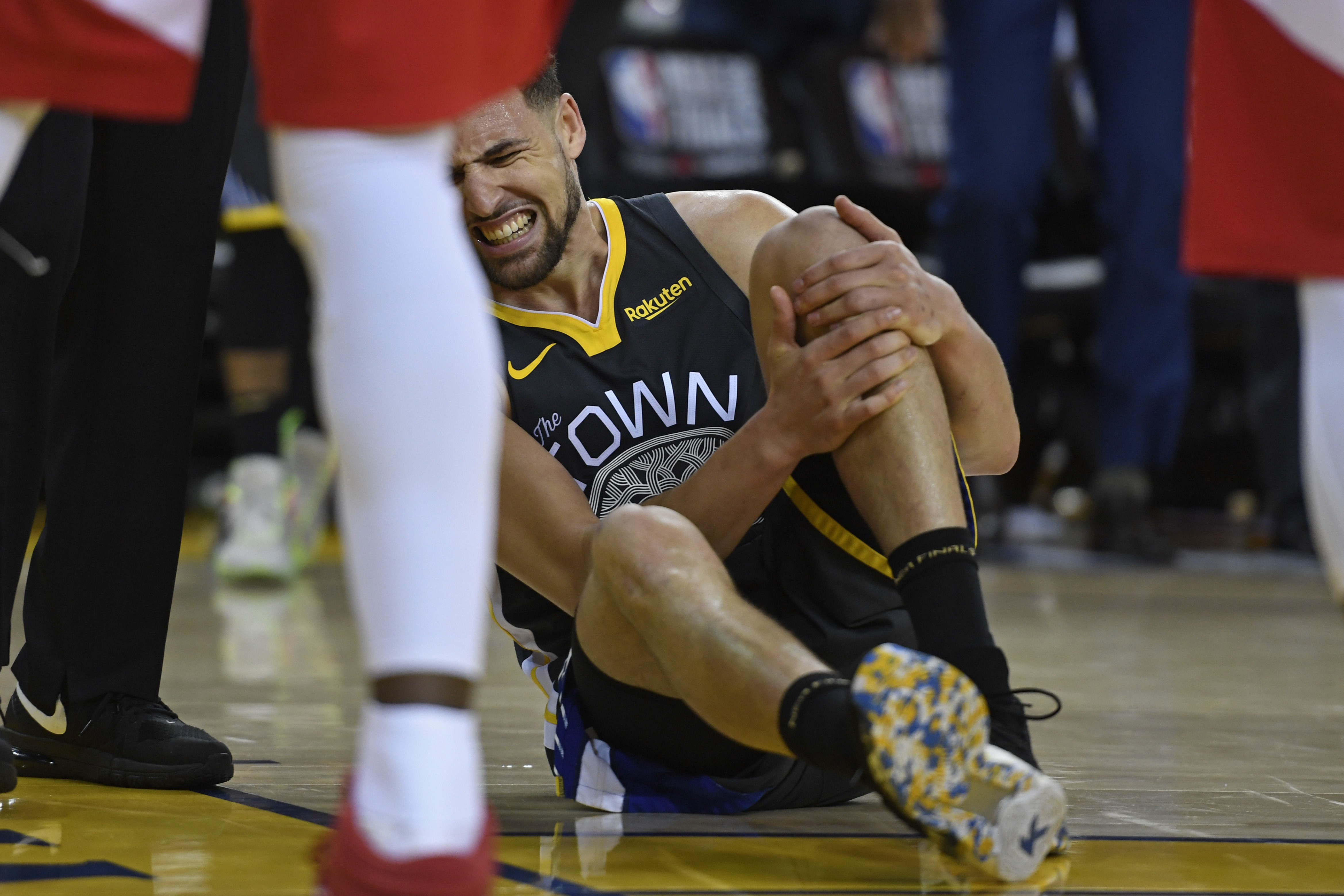 Golden State Warriors' Klay Thompson grimaces in pain after tearing the ACL in his left knee in the third quarter of Game 6 of the NBA Finals at Oracle Arena in Oakland, Calif., on Thursday, June 13, 2019. Thompson missed the 2019-20 season. (Jose Carlos Fajardo/Staff Archives)