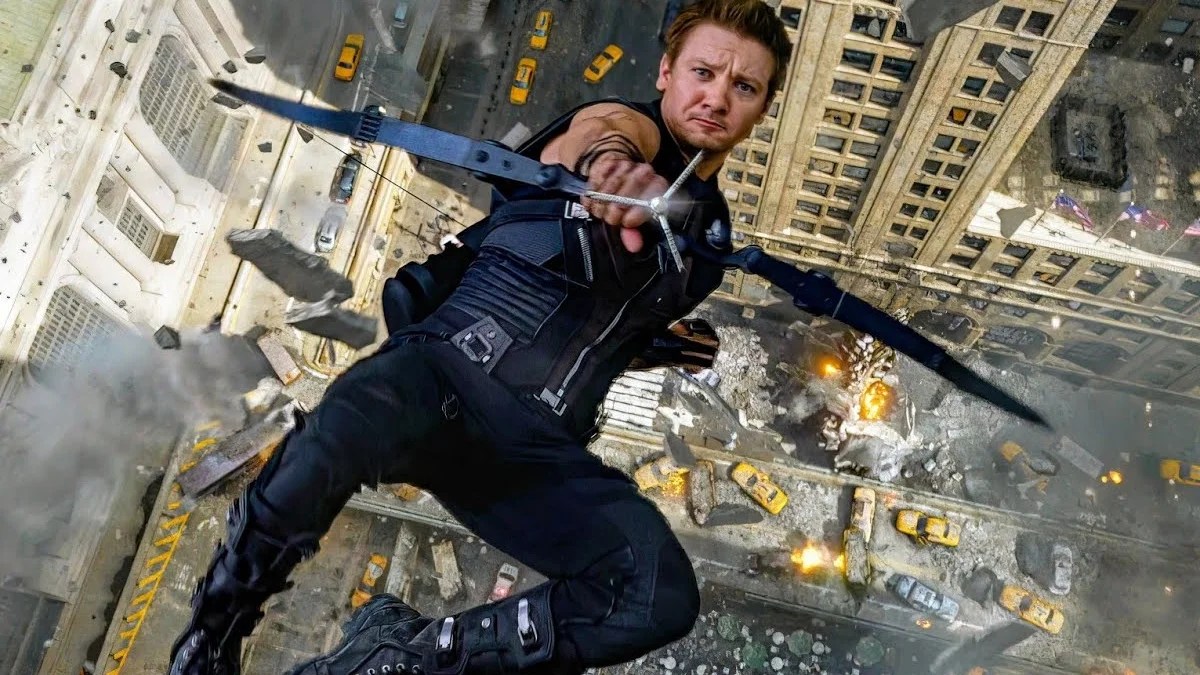 Jeremy Renner as Hawkeye in the Battle of New York, falling from a building as he fires his bow upward.