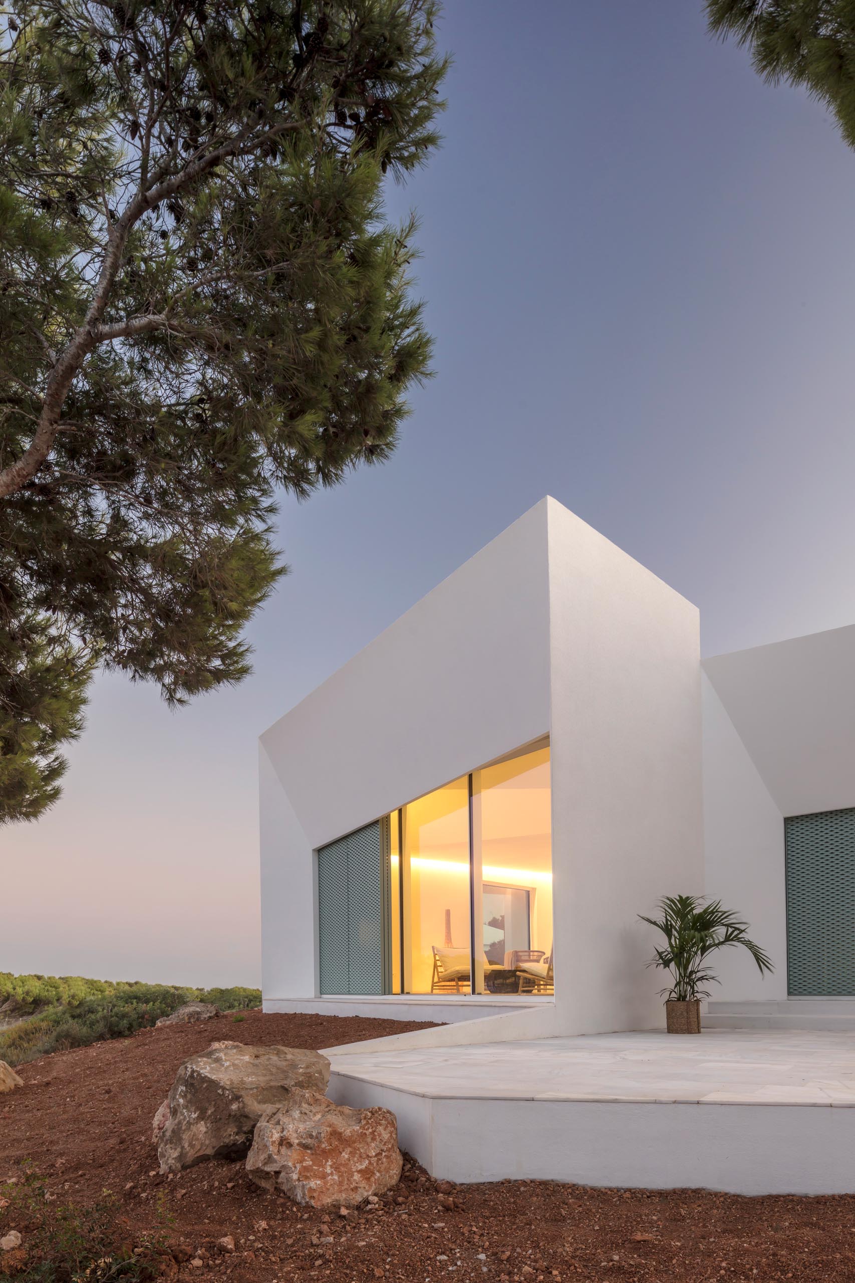 The Modern White Minimalist Exterior Of This Home Is Softened By The