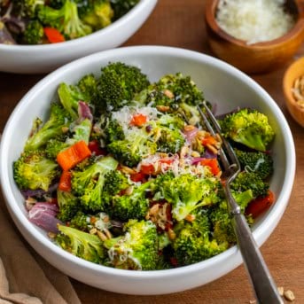 Bowls of Roasted Broccoli Salad on a wooden table.