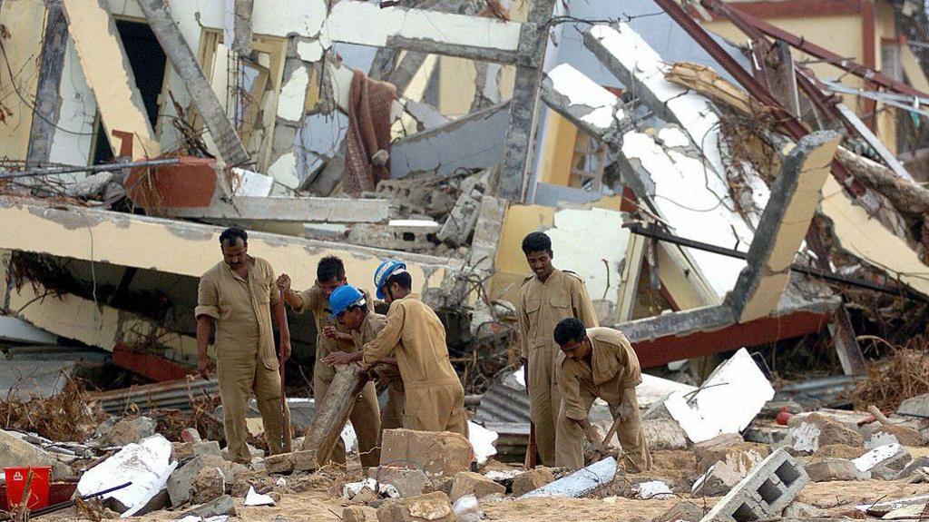 MALACCA, INDIA: Indian airforce personnel attempt to uncover documents from a time record room in Malacca on Car Nicobar Island, 07 January 2005,which was totally destroyed by the tsunamis of 26 December 2004. Almost 1,200 people are listed as killed, with 5,600 missing on the Andamans archipelago. Some 44,000 survivors are housed in shelters on the Indian Ocean tropical chain of over 500 islands strung across 800 kilometres (500 miles) and located just east of Sumatra.