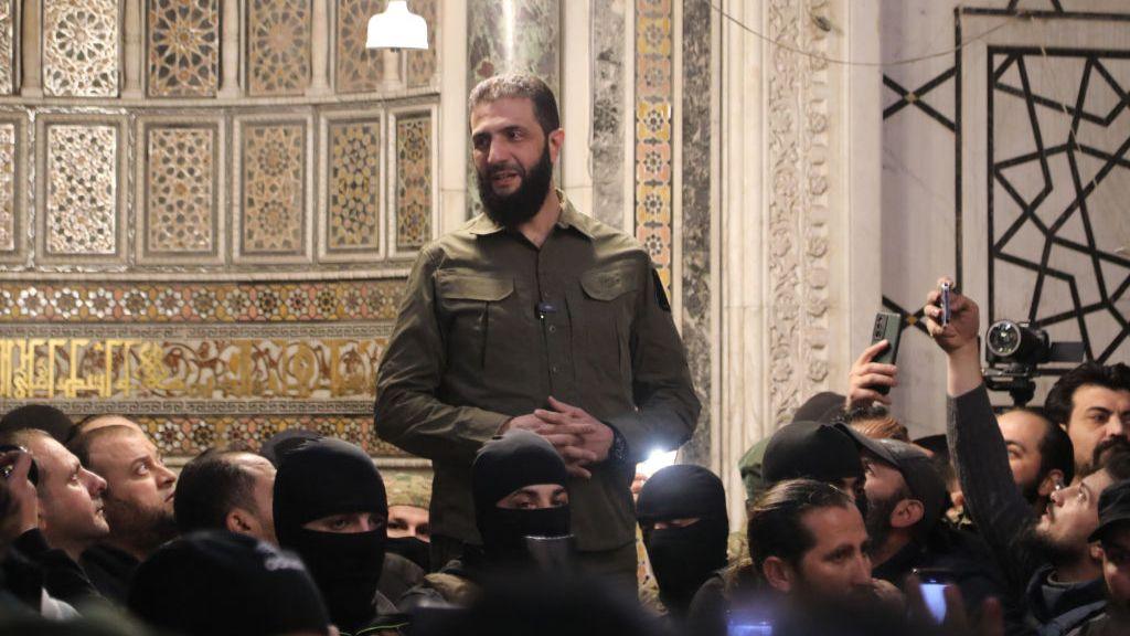 Abu Mohammed al-Jolani addresses a crowd inside the Umayyad Mosque in Damascus