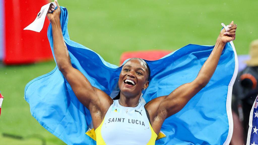 Julien Alfred celebrates Olympic 100m gold