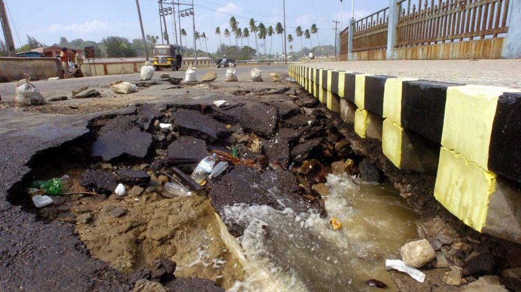 An picture taken 28 December 2004 shows a partly-collapsed beach side street in the vincinity of Port Blair, the capital city of India's southeastern Andaman and Nicobar Islands state. Huge waves triggered by an earthquake 26 December, killed at least 4000 people on the islands leaving thousands of people missing and countless numbers homeless in India as the death toll crossed 8500 from a tsunami that slammed into unprotected coasts across Asia.