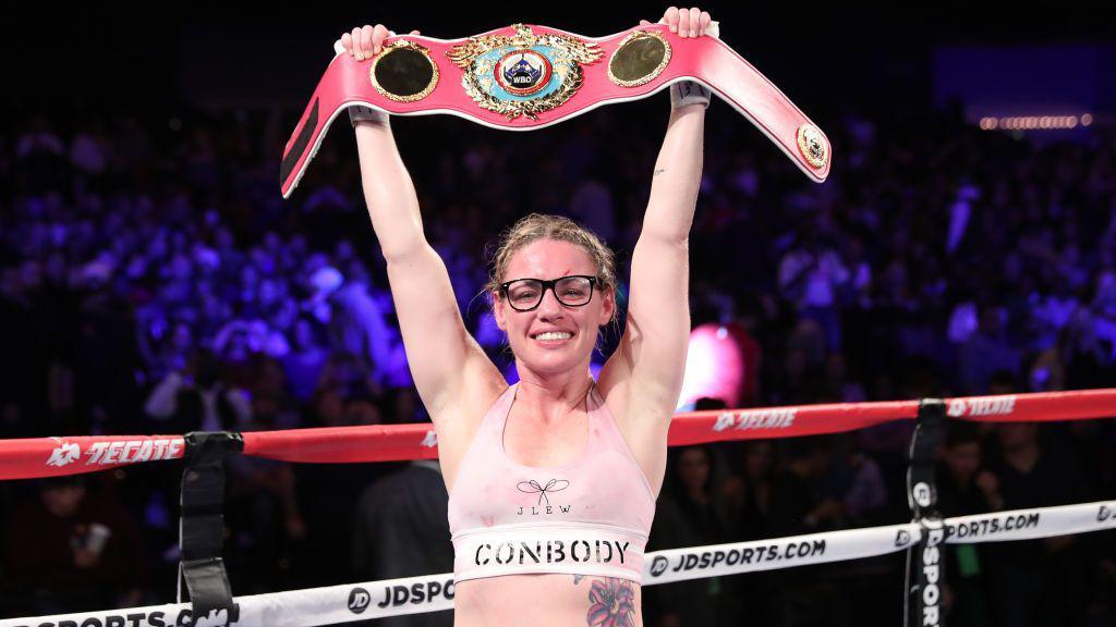 Heather Hardy holds up the WBO featherweight title