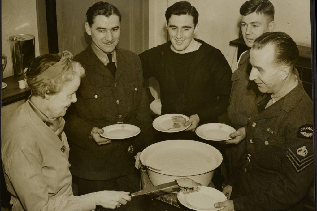 The Silver-Haired Lady At The Beaver Club, cooking for the soldiers at the club and serving them food