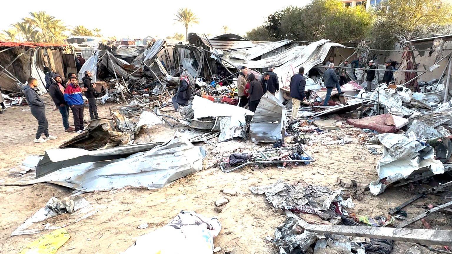 Palestinians inspect damage to a tented camp in the al-Mawasi area, near Khan Younis, following an Israeli air strike that medics said killed 20 people, in the southern Gaza Strip (5 December 2024)