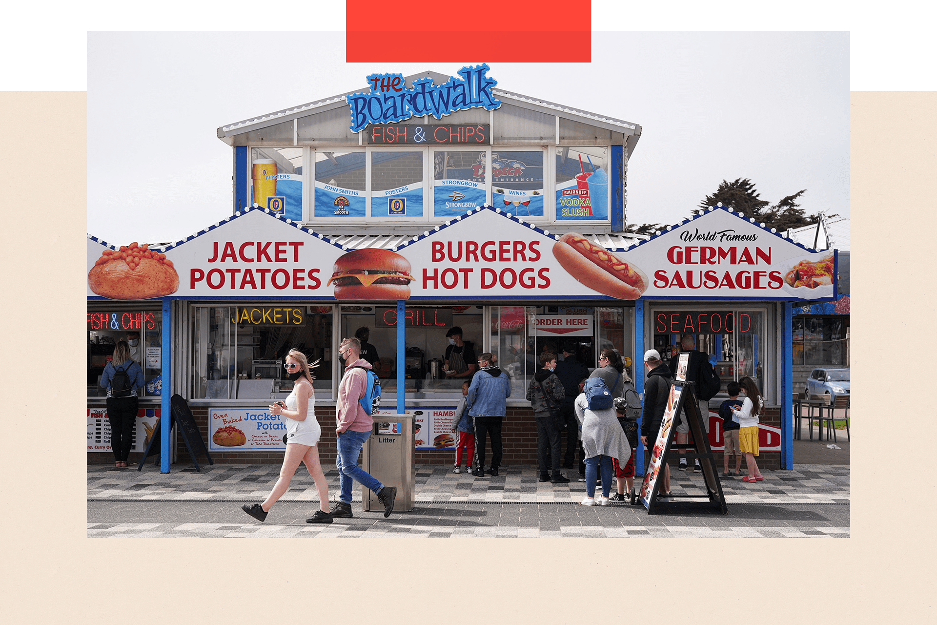 People queue outside a fast food kiosk on the promenade in Skegness