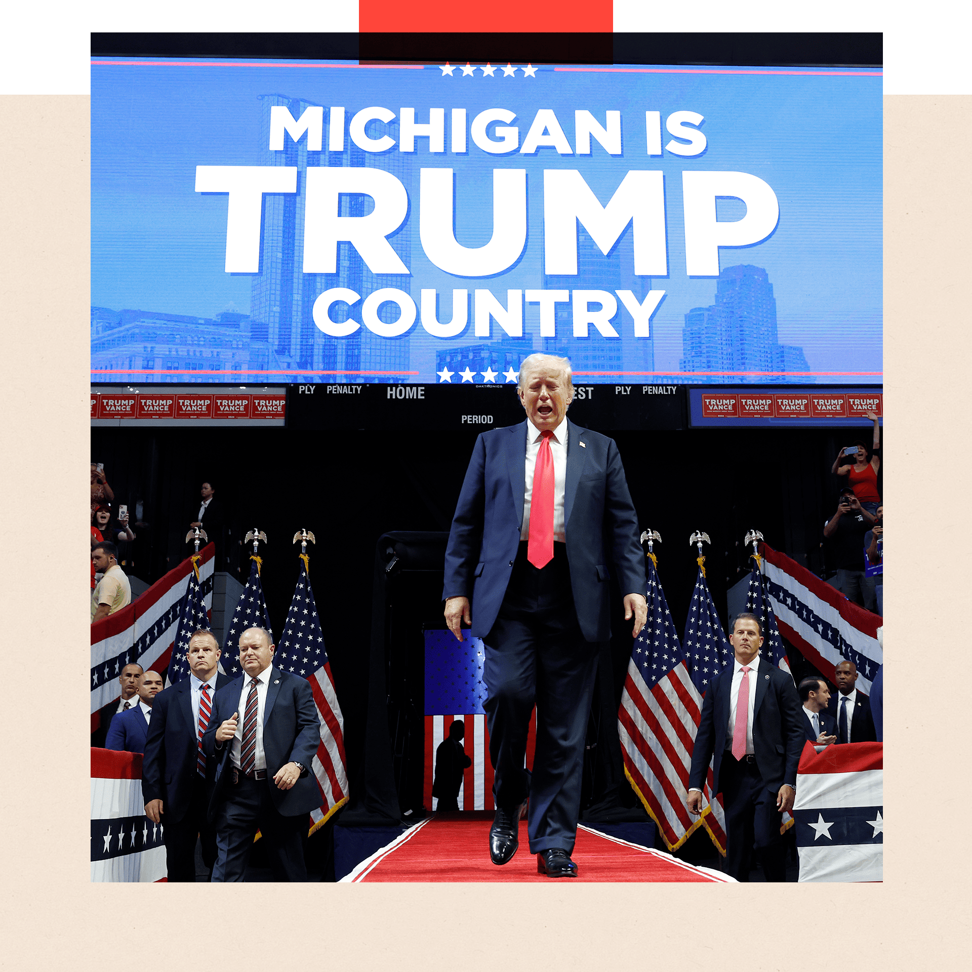 Donald Trump walks in front of a sign that reads 'Michigan is Trump country'