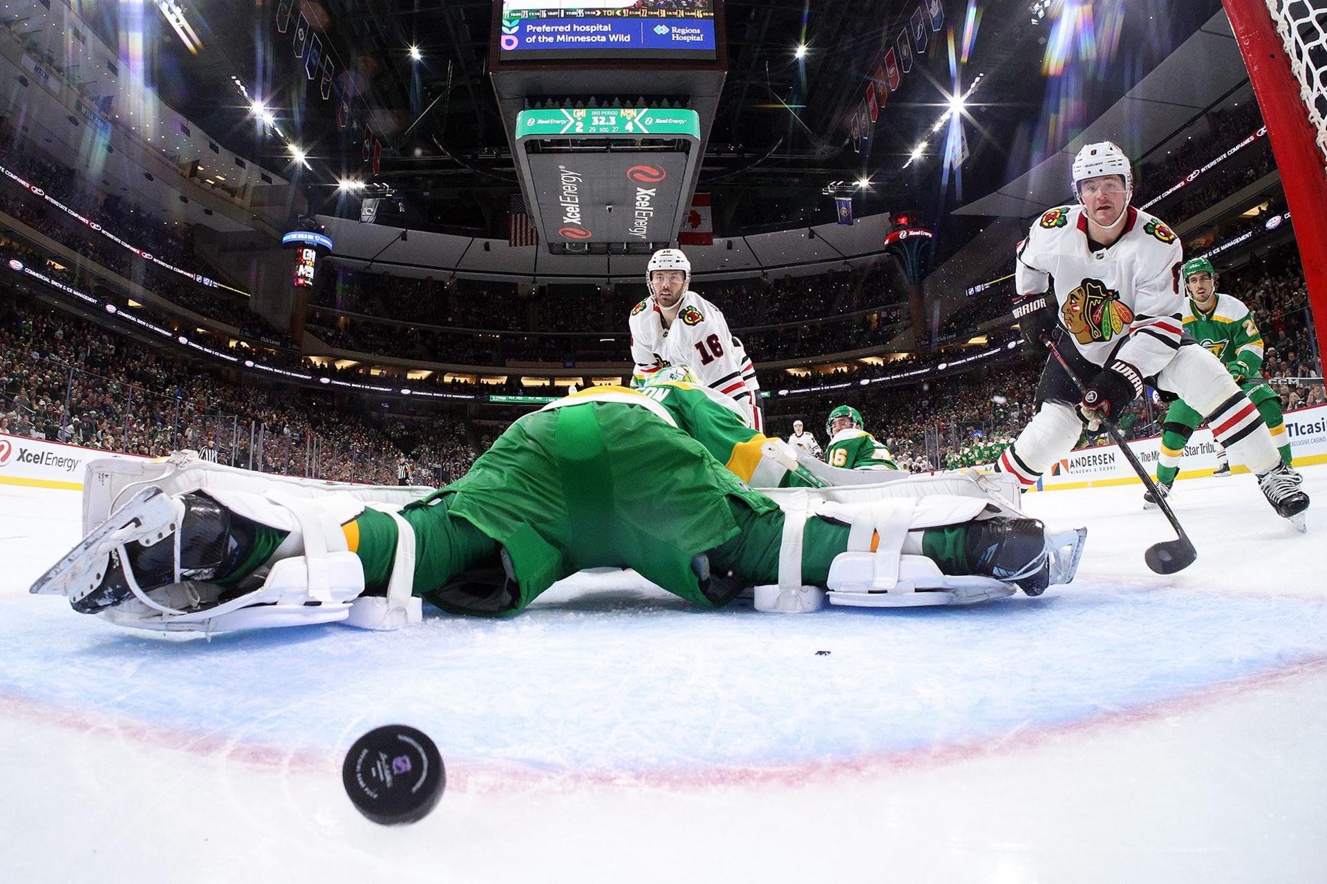 Jason Dickinson of the Chicago Blackhawks scores a goal against Filip Gustavsson of the Minnesota Wild in the third period at Xcel Energy Center in St Paul, Minnesota. The Wild defeated the Blackhawks 4-3.