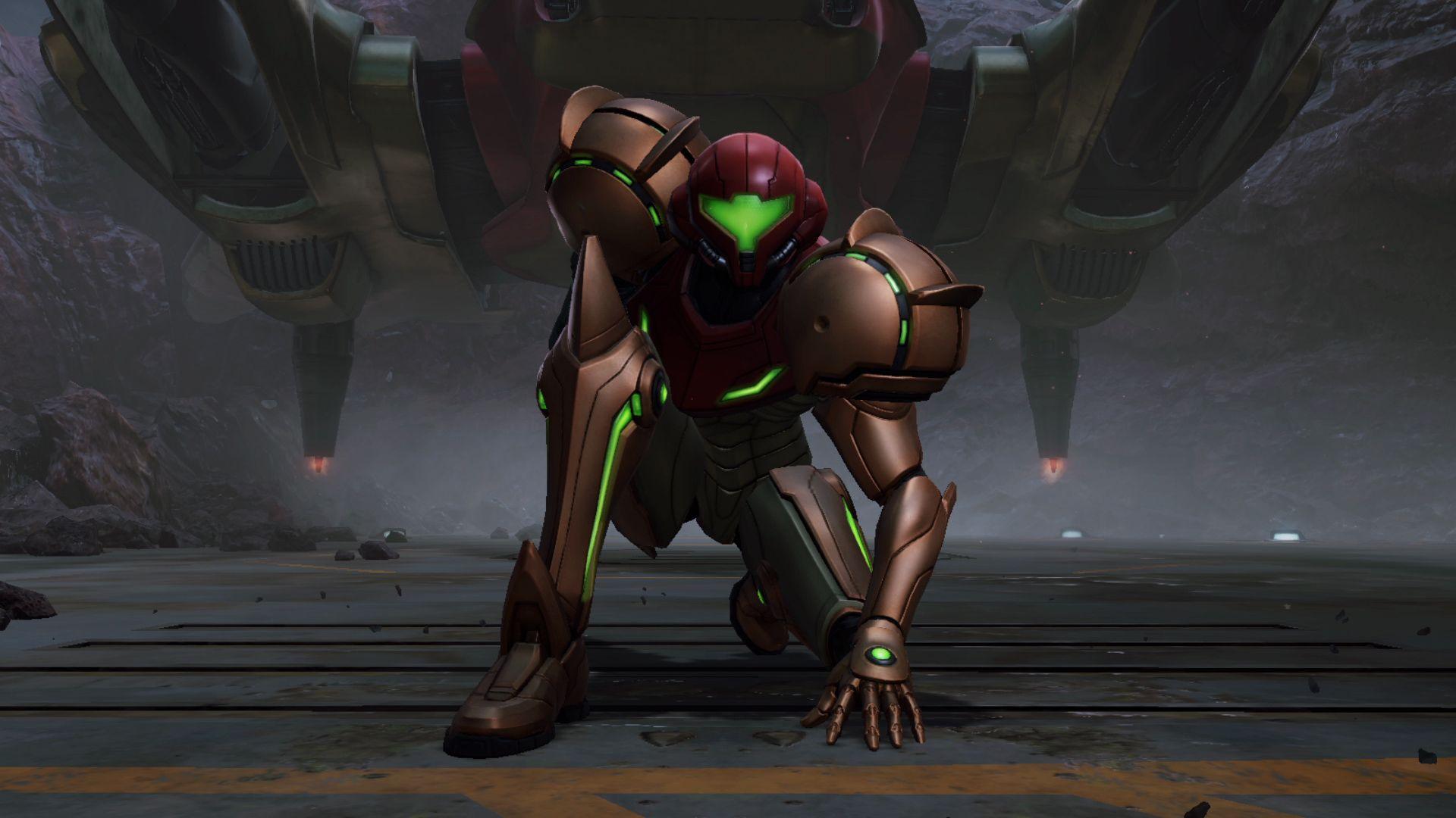 Bounty hunter Samus Aran, wearing her famous orange armour, crouches, one hand placed on the ground, as she looks forward into the distance. Behind her is the underside of her spacecraft, which appears to have just landed on a desolate planet.