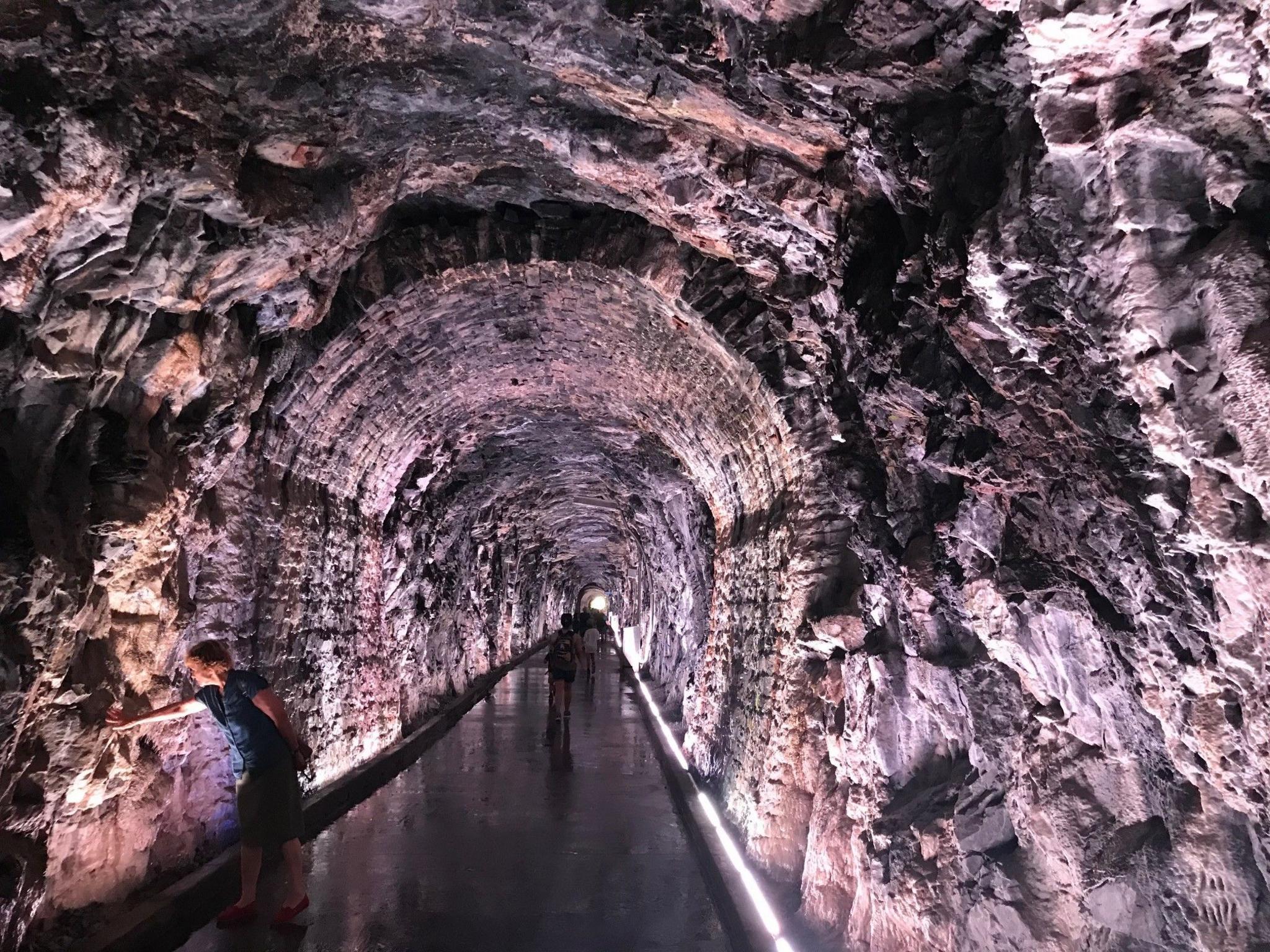 A rough rock tunnel, now used as a footpath