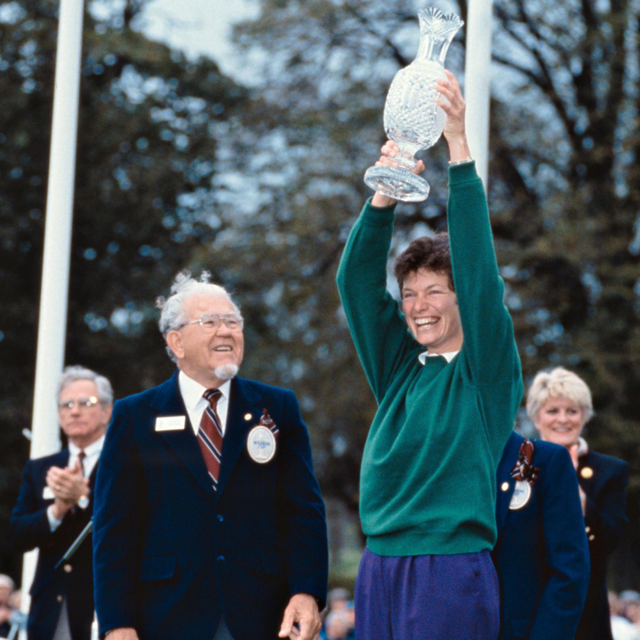 Europe captain Mickey Walker raises the Solheim Cup in 1992 after being handed it by Karsten Solheim