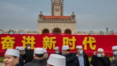 Party members from the Hui Muslim minority stand together at an exhibition highlighting Chinese President Xi Jinping's years as leader, as part of the upcoming 20th Party Congress, on October 12, 2022 in Beijing, China.