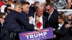 Trump protected by Secret Service agents at rally after shooting