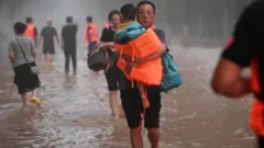 Trapped people are evacuated at flood-hit Tazhao village on August 1, 2023 in Zhuozhou, Hebei Province of China. Rescue and relief efforts were underway after heavy rains triggered floods in Zhuozhou