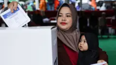 Woman casts ballot in 2024 Indonesia election