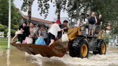 Residents rescued on a bulldozer