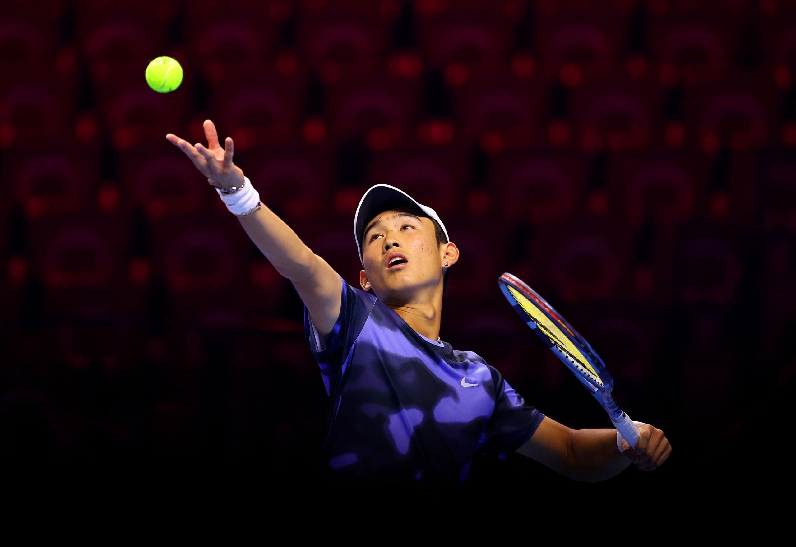 Shang Juncheng of China serves against Luca Van Assche of Franceduring the Men's Singles Group Stage match on day one of the Next Gen ATP Finals presented by PIF at King Abdullah Sports City in Jeddah, Saudi Arabia