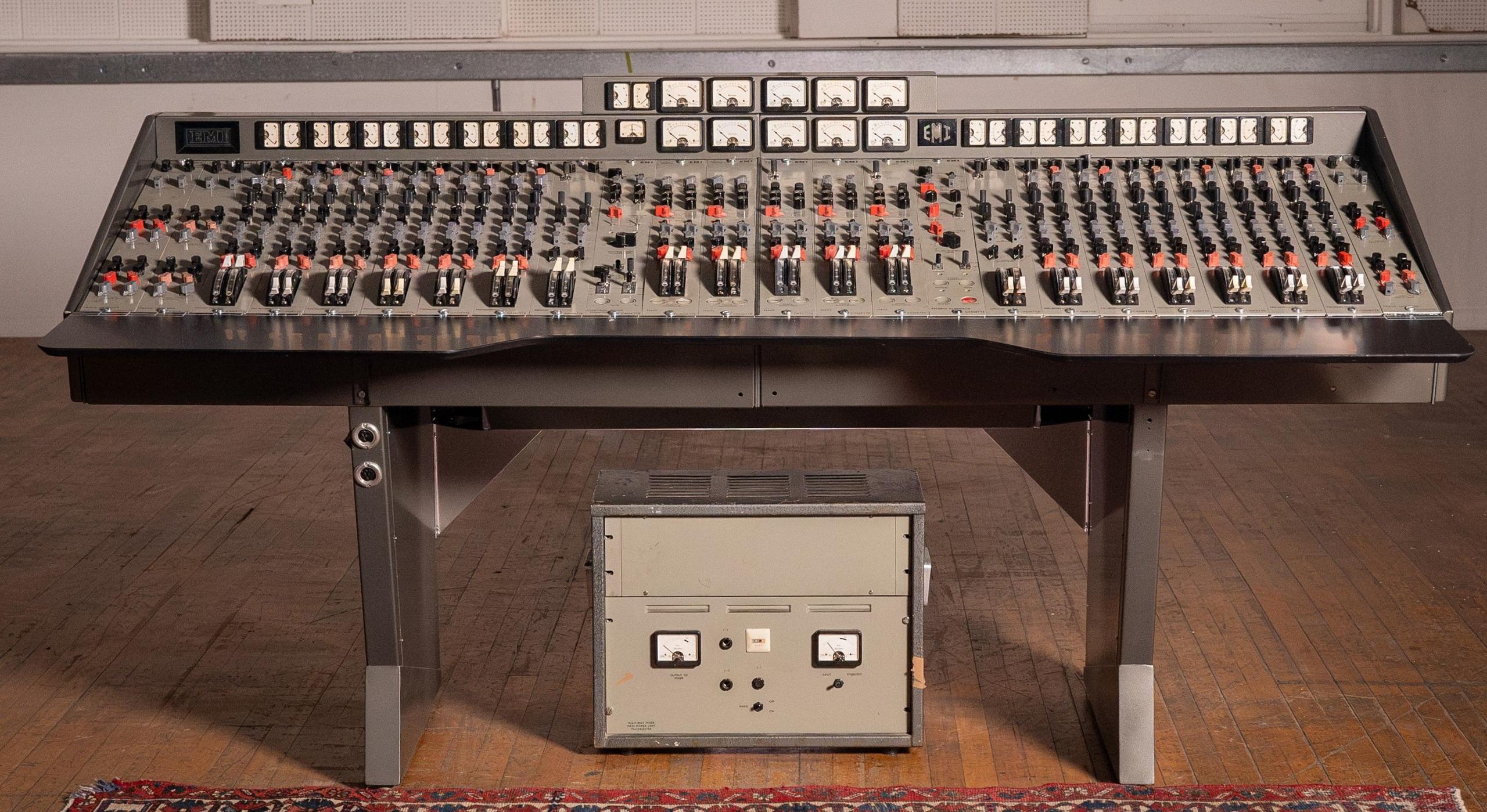 The EMI TG12345 console sits in a room. It has countless switches and dials to help record music.