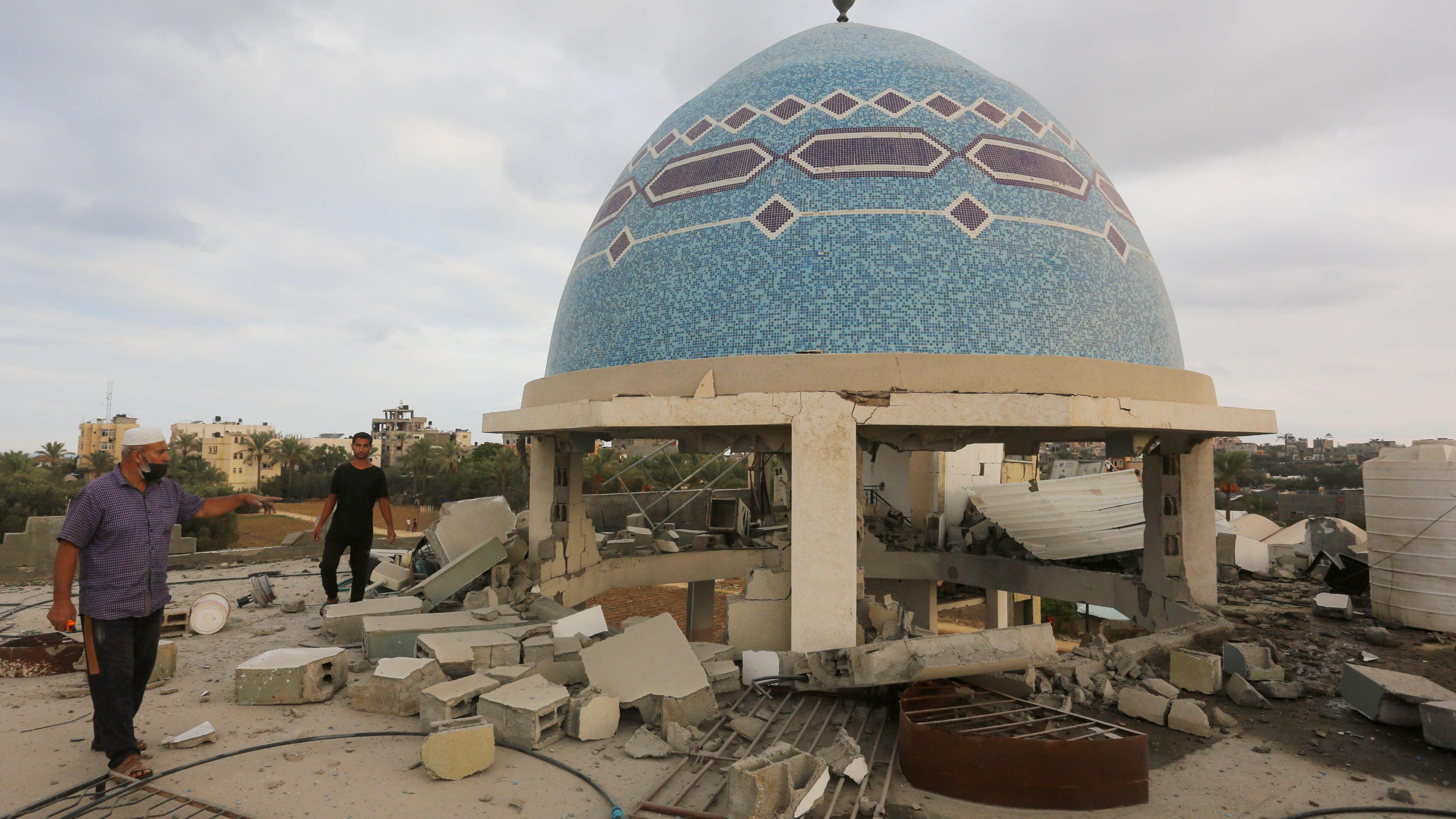 Palestinians inspect the rubble of a mosque, which was damaged in Israeli attack in Deir al-Balah, Gaza on 6 October, 2024