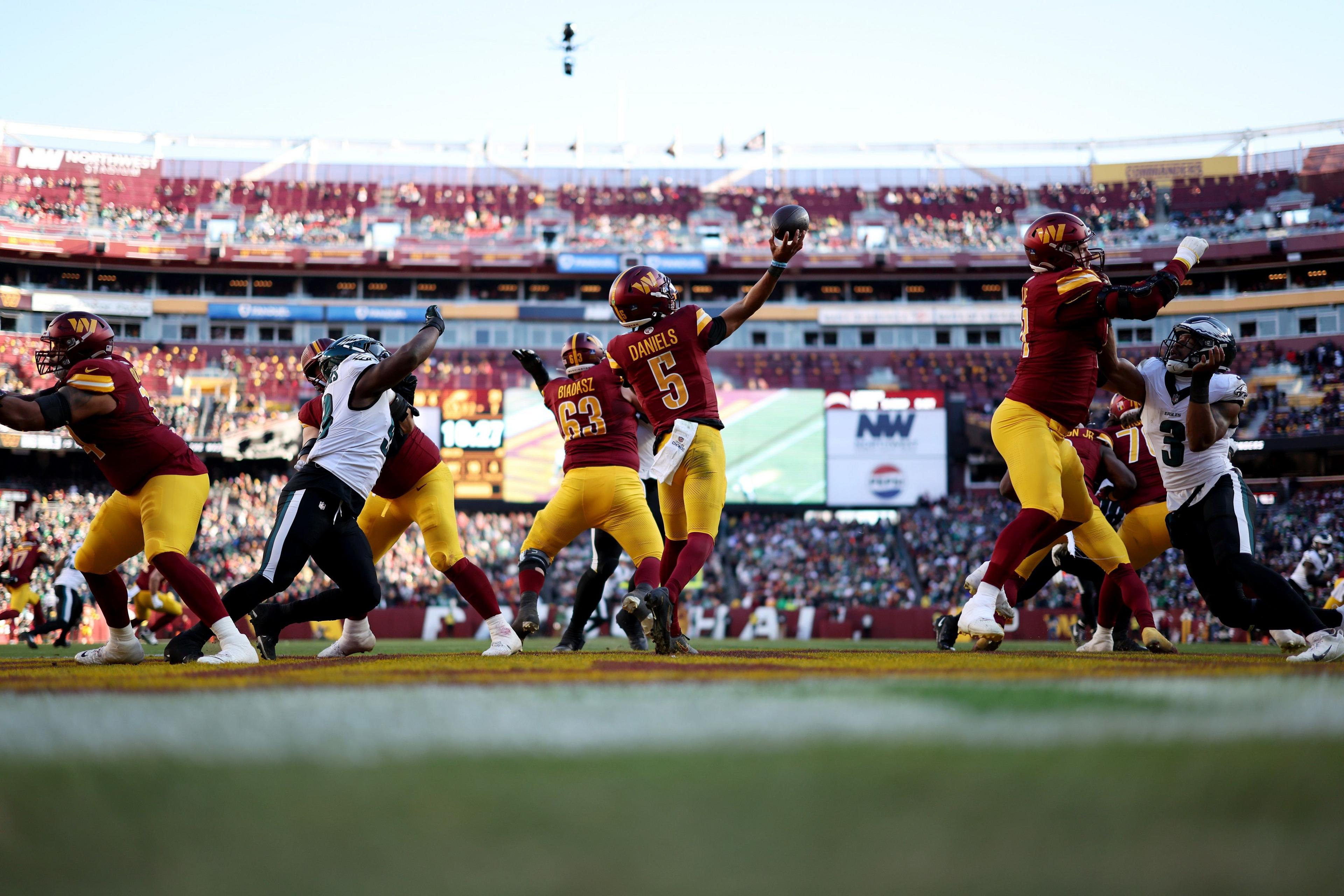 Jayden Daniels throws the ball for Washington against Philadelphia