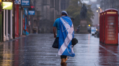 A lone YES campaign supporter walks down a street in Edinburgh after the result of the Scottish independence referendum, Scotland, Friday, Sept. 19, 2014