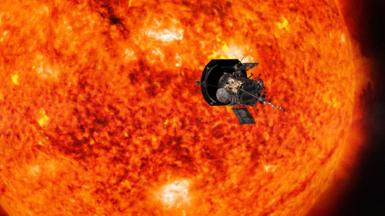 Artist's impression of Parker Solar Probe spacecraft flying past the Sun, which appears bright orange, yellow, brown and black and is substantially larger than the spacecraft in the foreground. 