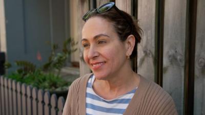 A woman on a Sydney street speaks to the camera